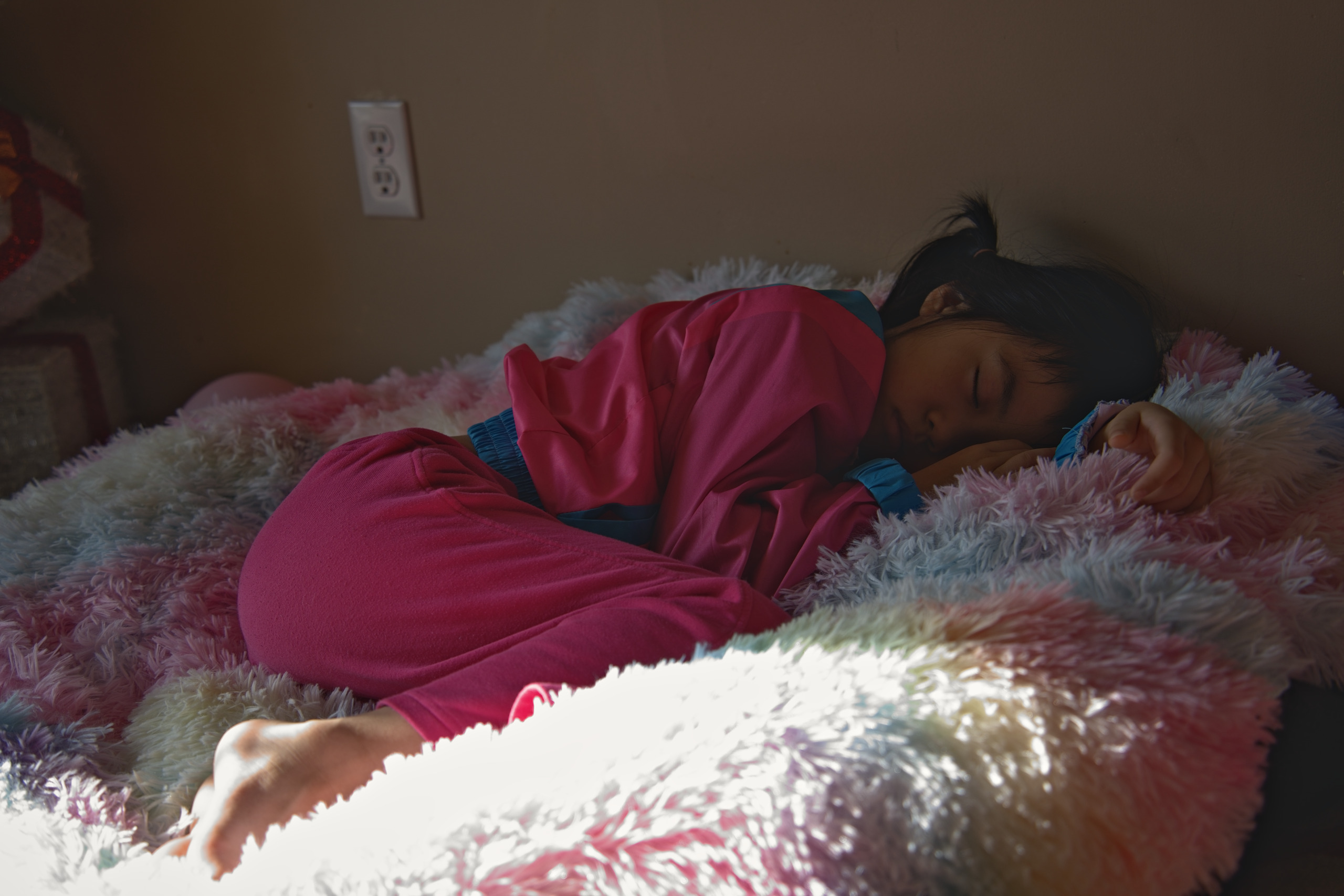Child asleep on a soft blanket during a lifestyle family session — Twin Cities family photography by Loon & Birch Photography