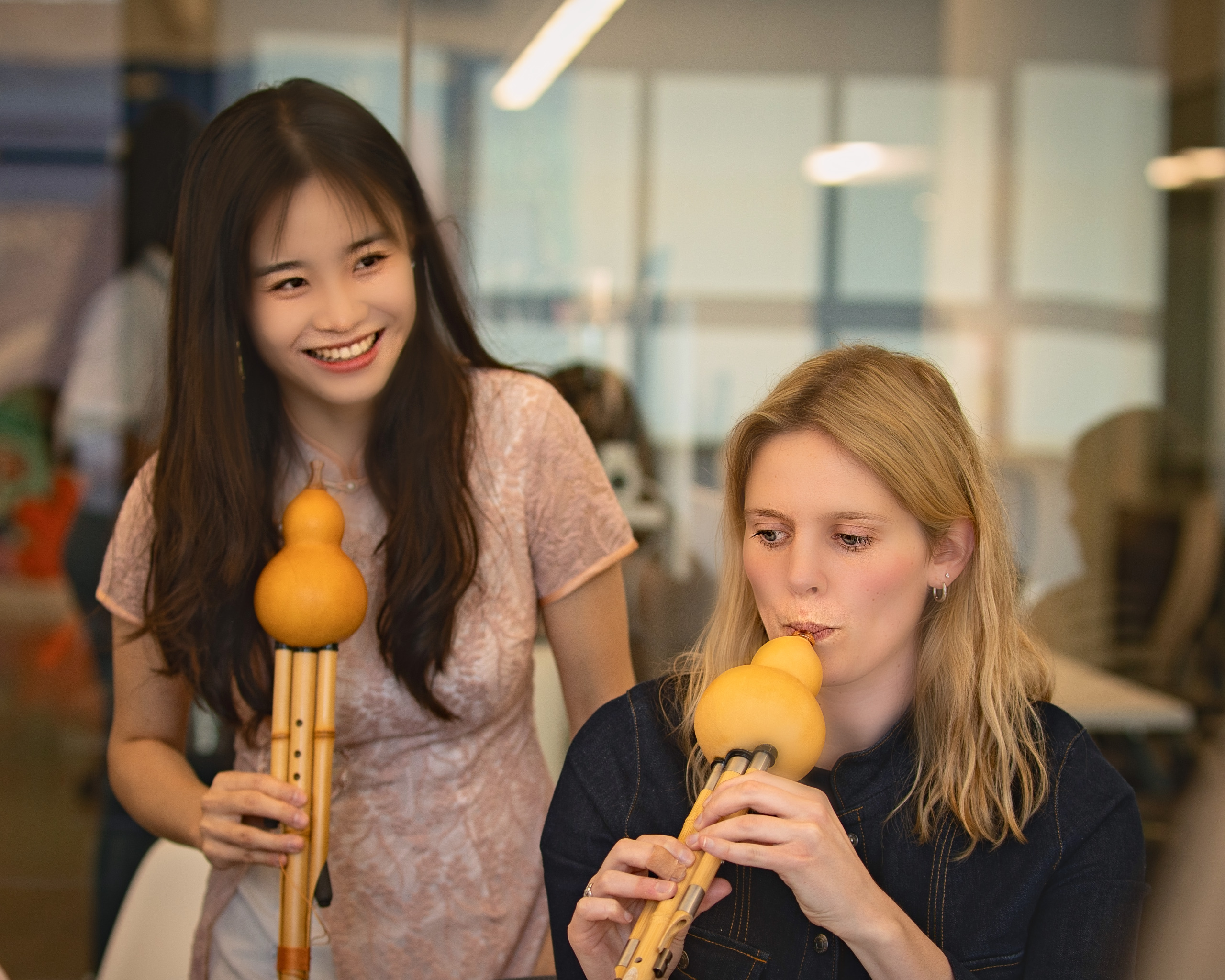 Music instructor teaching a student to play the hulusi flute — Twin Cities event and senior portrait photography by Loon & Birch Photography