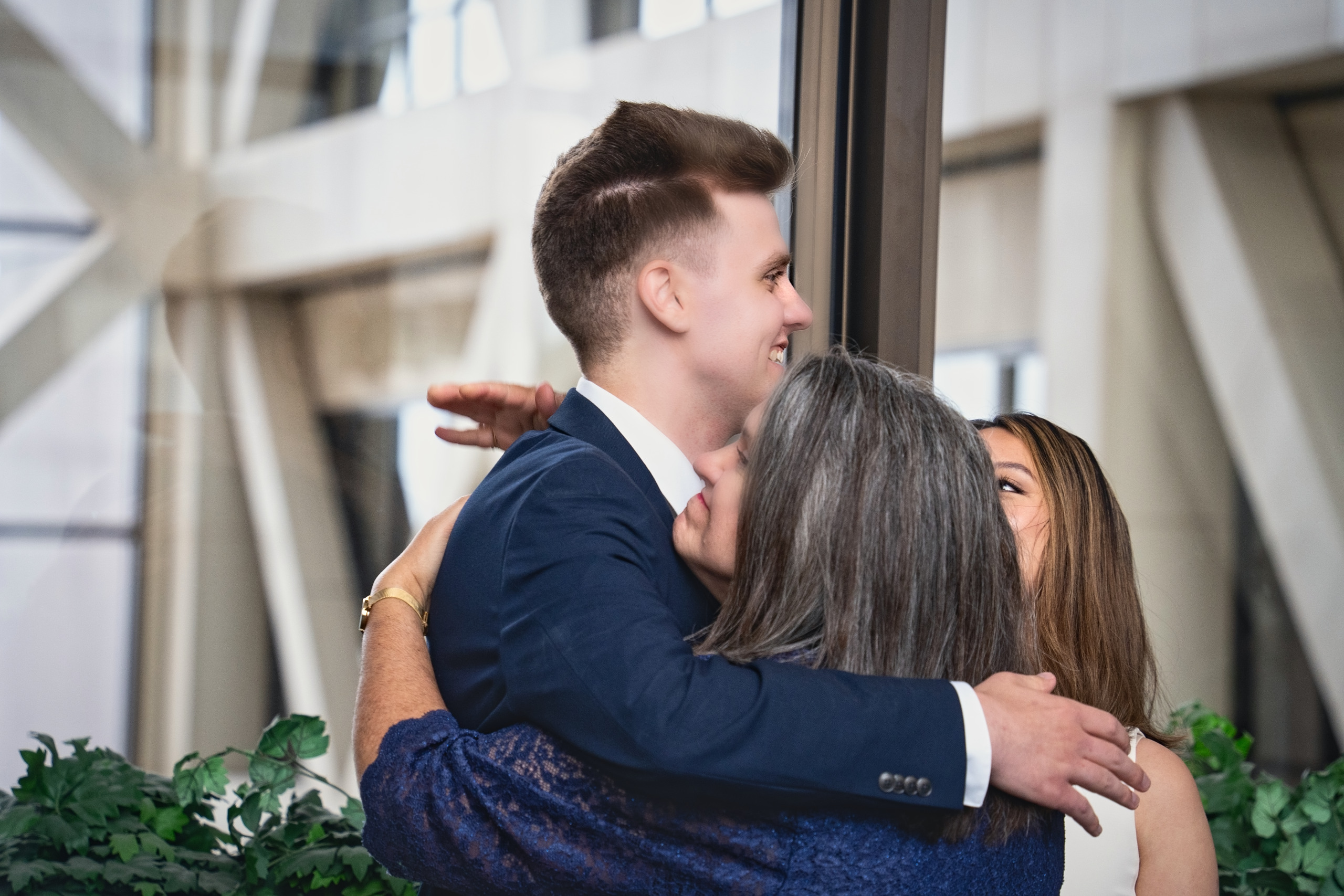 Groom embracing his mother after the wedding ceremony — Twin Cities wedding photography by Loon & Birch Photography