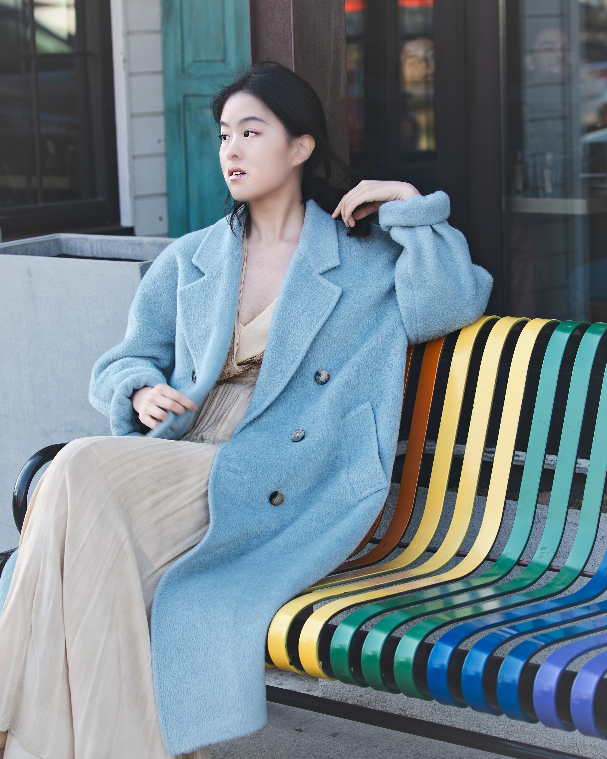 Fashion portrait of a woman seated on a colorful city bench — Twin Cities event and senior portrait photography by Loon & Birch Photography