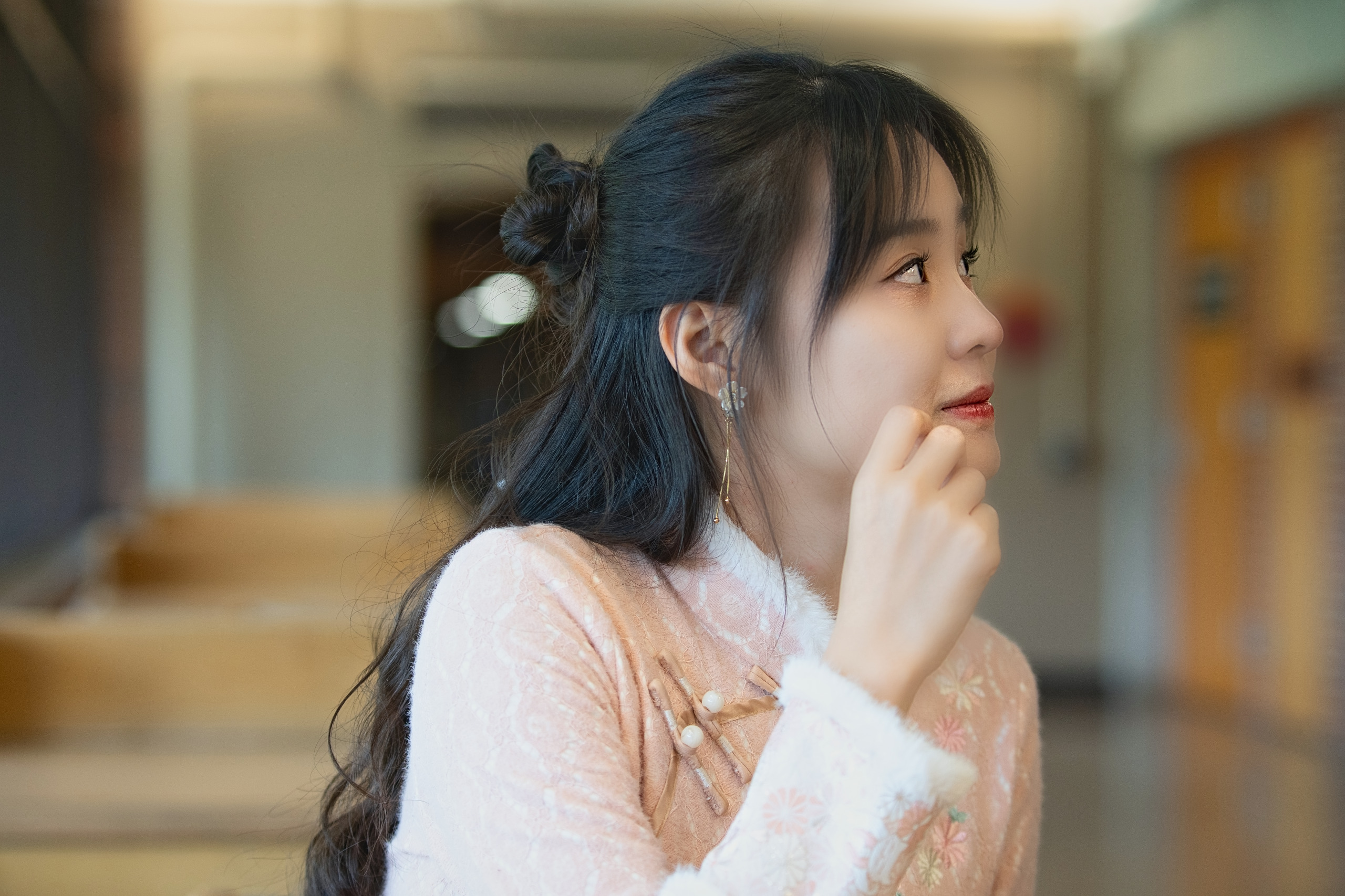 Young woman in a quiet hallway with soft background bokeh — Twin Cities event and senior portrait photography by Loon & Birch Photography