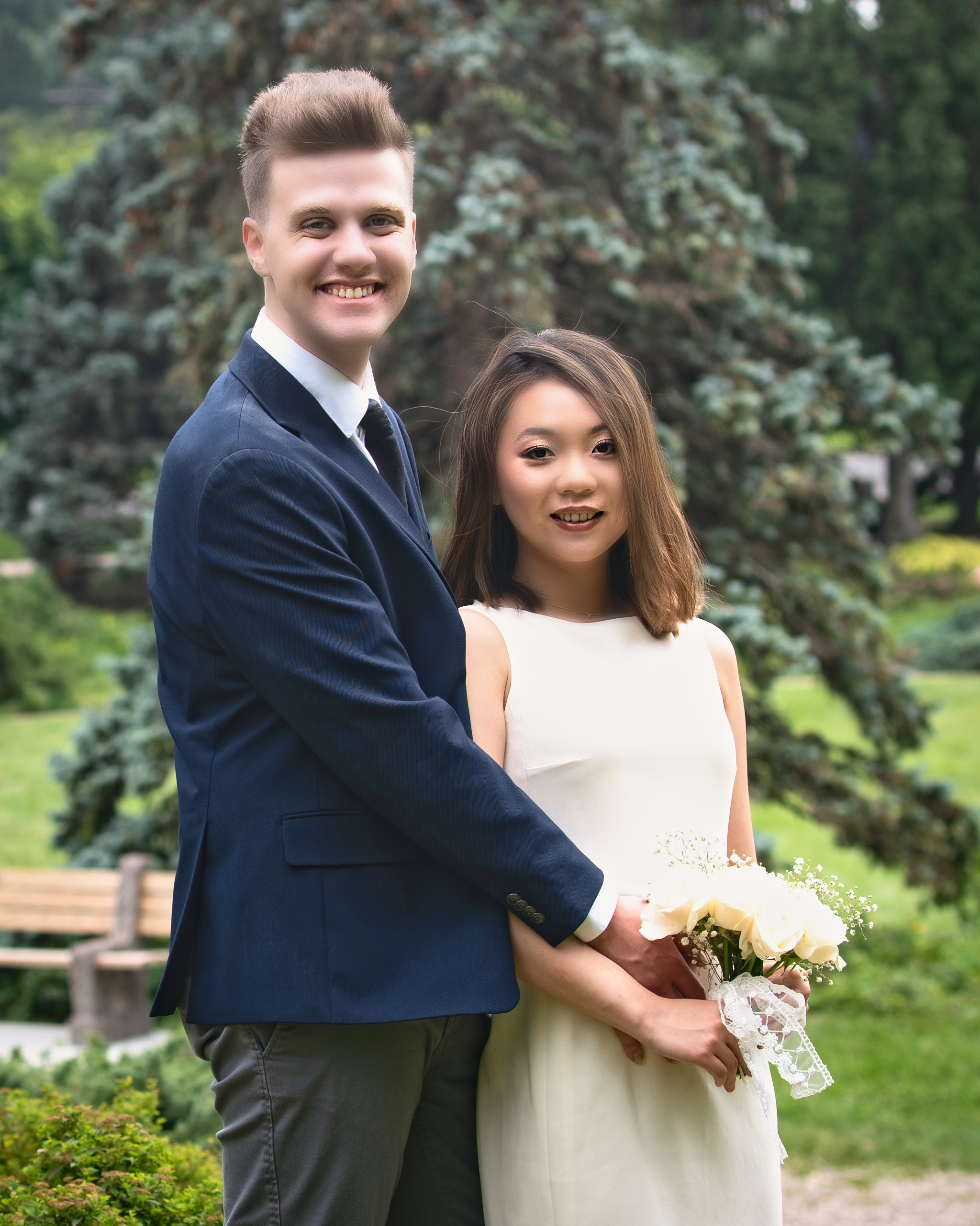 Newlywed couple smiling together in a lush garden after the ceremony — Twin Cities wedding photography by Loon & Birch Photography