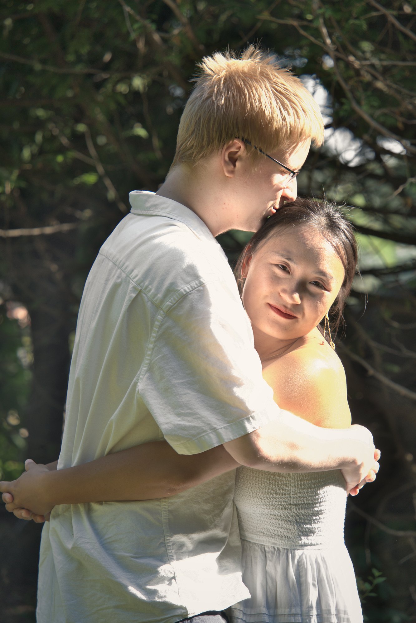 Woman smiling at the camera while wrapped in a warm embrace — Twin Cities couples and engagement photography by Loon & Birch Photography